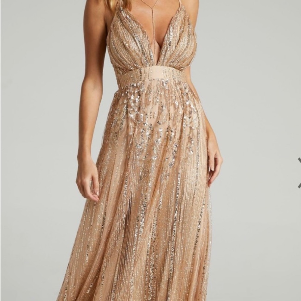 Sheer mesh outer layer with intricate patterns of sequins and glitter